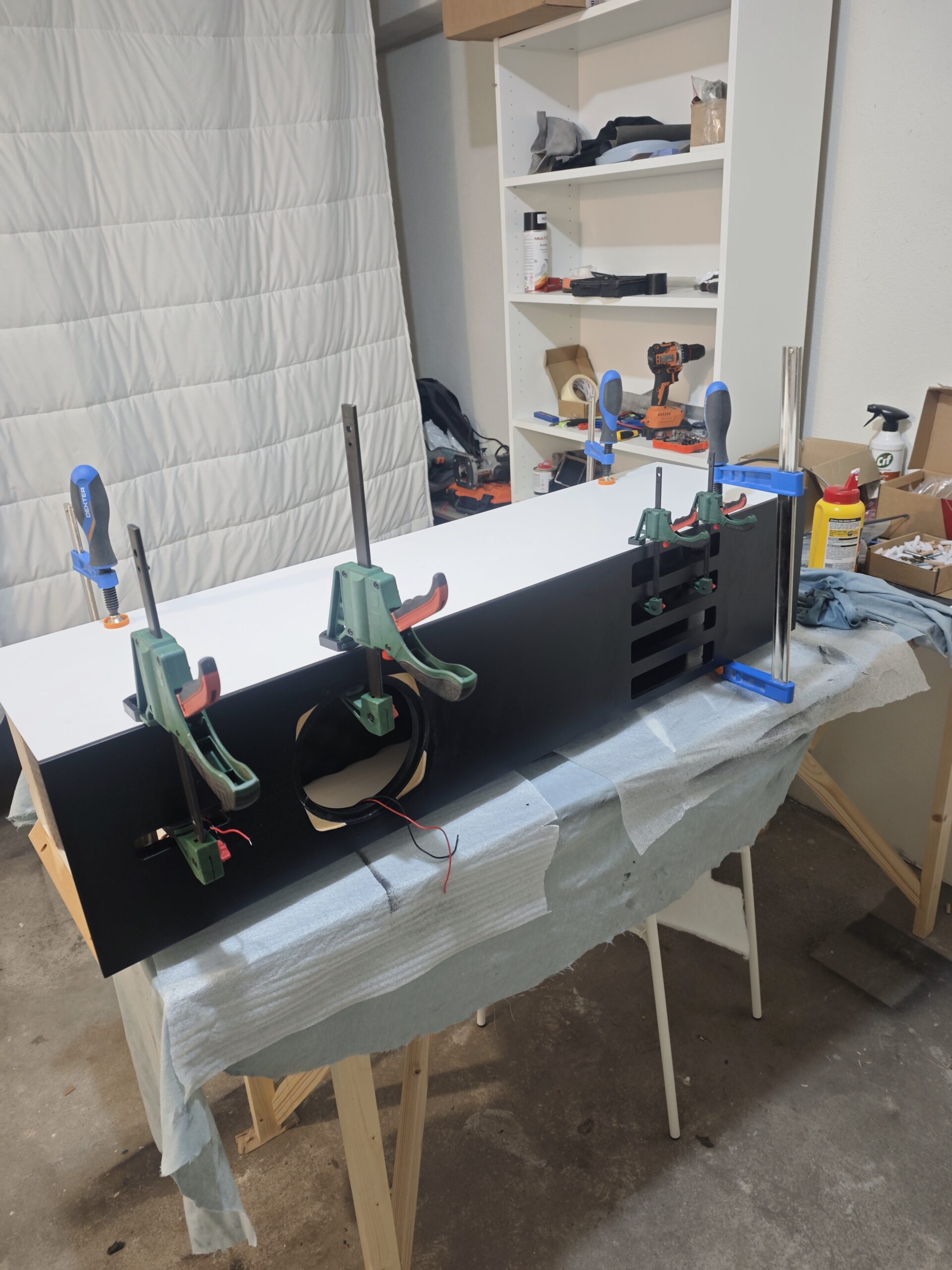 Real workshop photograph: a cabinet clamped during assembly.